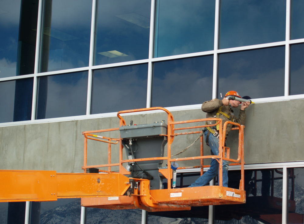 Commercial caulking. Caulking the windows of a commercial building.